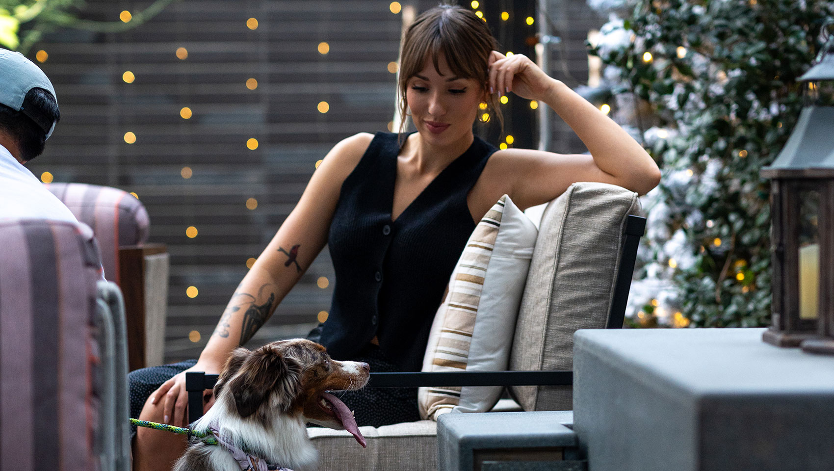 woman with dog on outdoor seating area