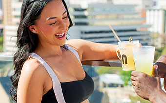 Woman with cocktail on Tenfold Rooftop